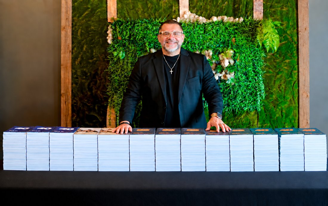 Manny Rivera at his book table