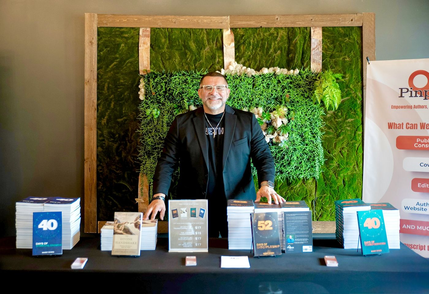 Manny Rivera at his book table
